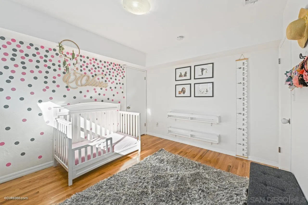 3726 Nassau Drive San Diego, CA 92115 - Photo 16 of 37 a bedroom with a bed and wooden floor