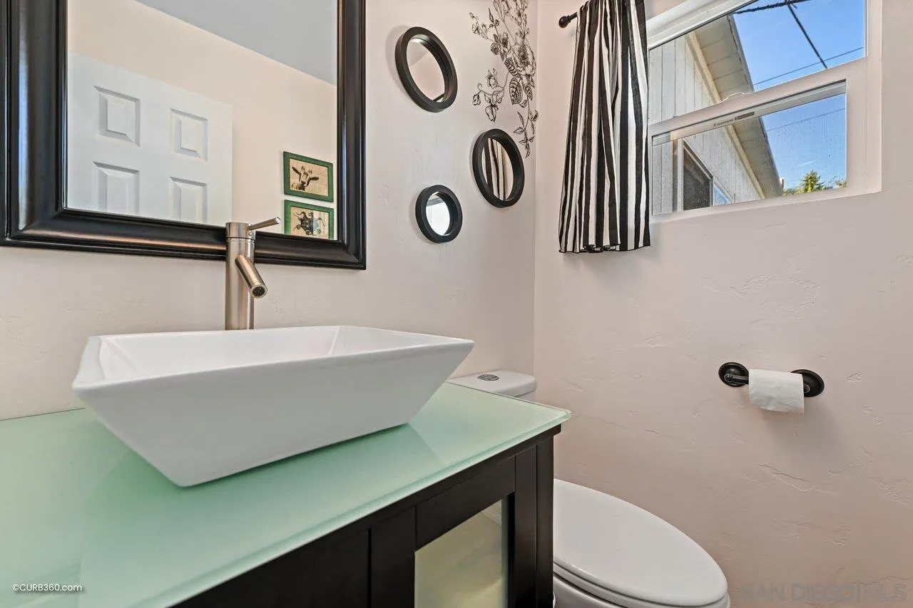 3726 Nassau Drive San Diego, CA 92115 - Photo 19 of 37 a bathroom with a toilet a sink and mirror
