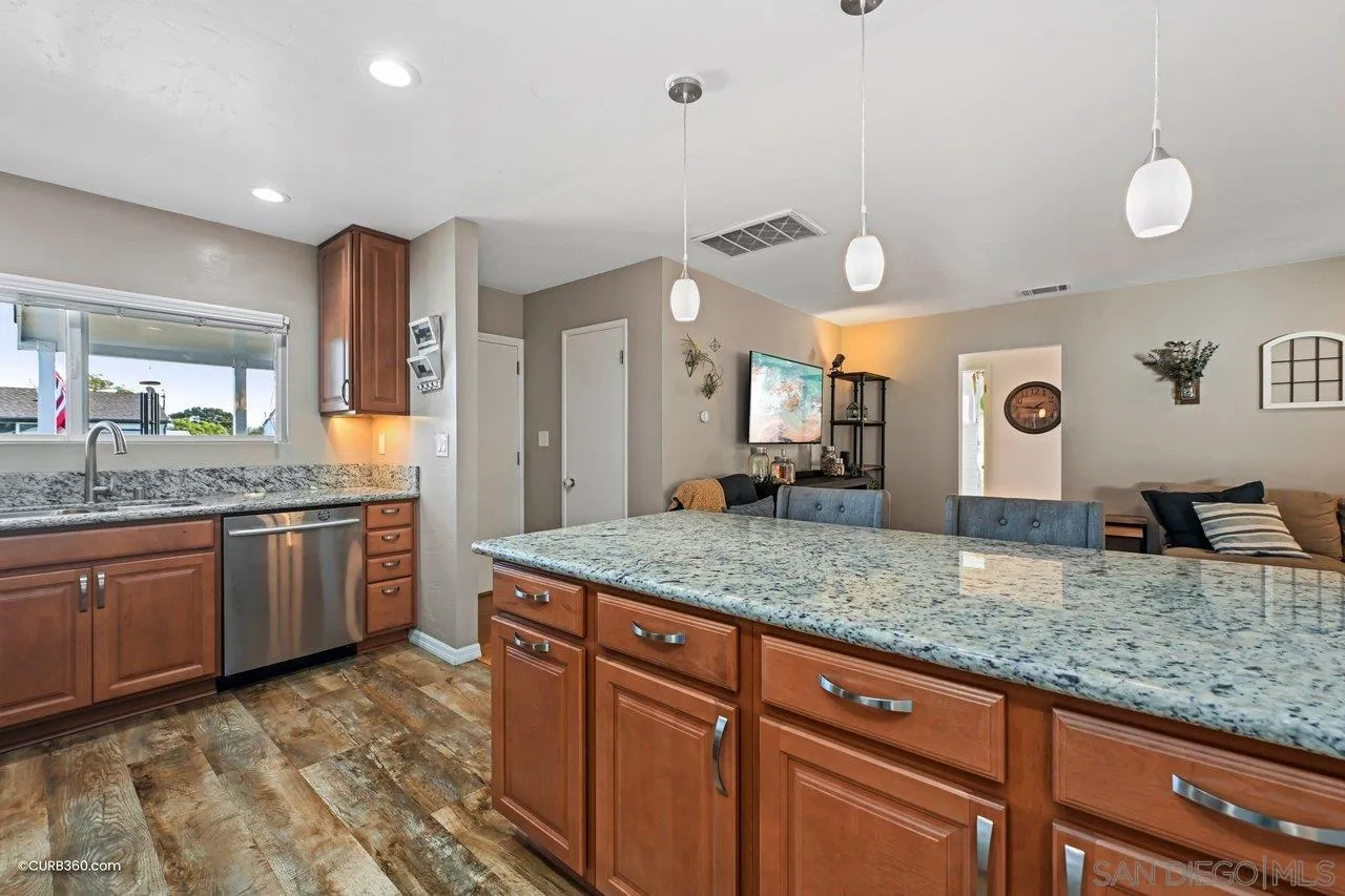 3726 Nassau Drive San Diego, CA 92115 - Photo 4 of 37 a bathroom with a granite countertop sink and a mirror