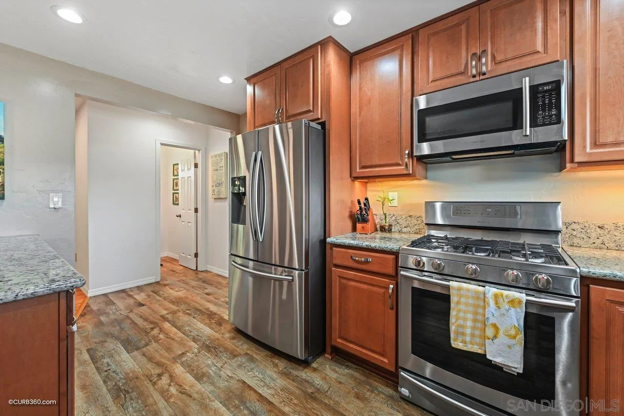 3726 Nassau Drive San Diego, CA 92115 - Photo 5 of 37 a kitchen with stainless steel appliances granite countertop a stove microwave and refrigerator