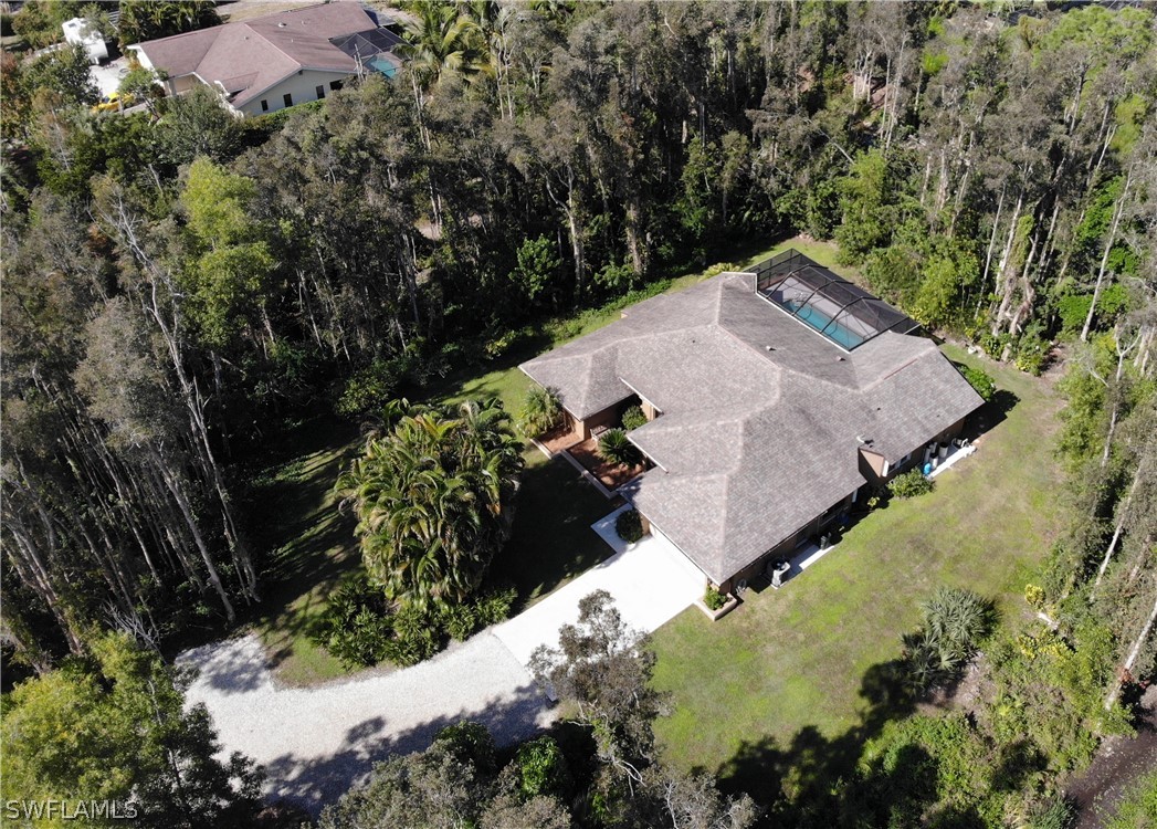 15252 Briar Ridge Circle Fort Myers, FL 33912 - Photo 2 of 25 an aerial view of a house with a yard and trees