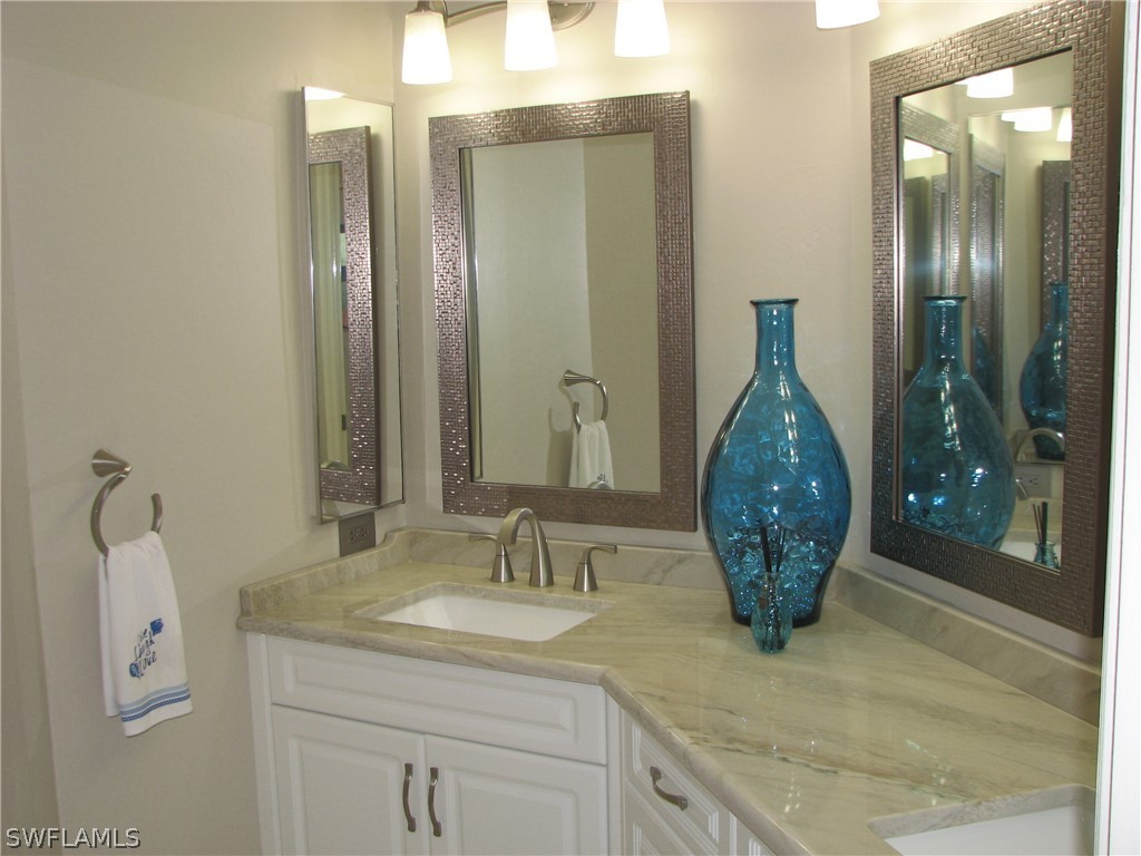 15252 Briar Ridge Circle Fort Myers, FL 33912 - Photo 21 of 25 a bathroom with a granite countertop sink and a mirror