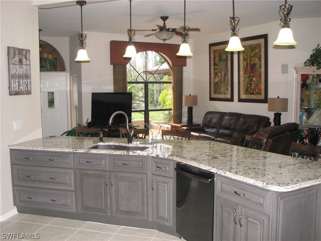 15252 Briar Ridge Circle Fort Myers, FL 33912 - Photo 8 of 25 a kitchen with a granite countertop sink and a large mirror