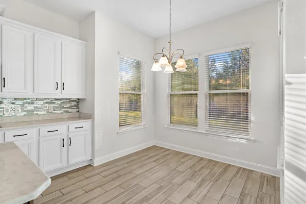 a kitchen with kitchen island granite countertop a sink cabinets and stainless steel appliances