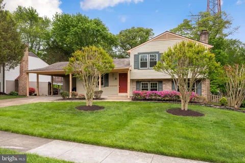 a front view of a house with garden and porch