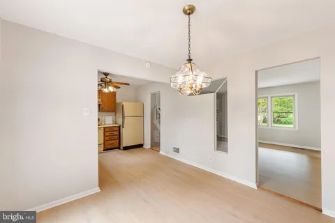 a kitchen with stainless steel appliances granite countertop a refrigerator sink and white cabinets