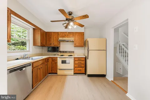a kitchen with a stove a sink and a refrigerator