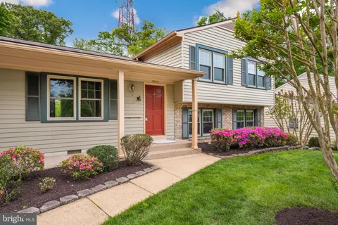 a front view of a house with a garden and potted plants