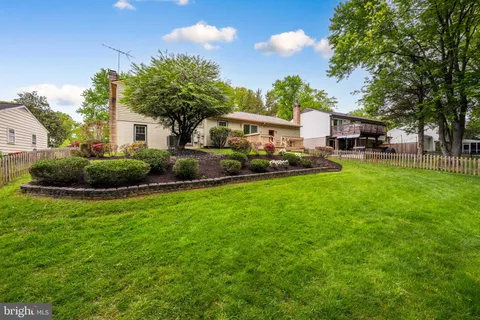 a view of a backyard with plants and a garden