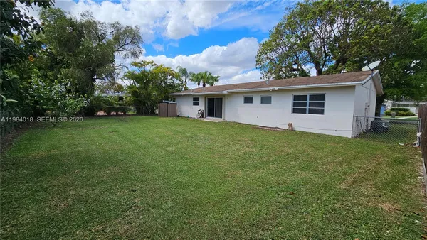 a view of a house with a backyard