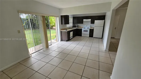 a open kitchen with cabinets and stainless steel appliances
