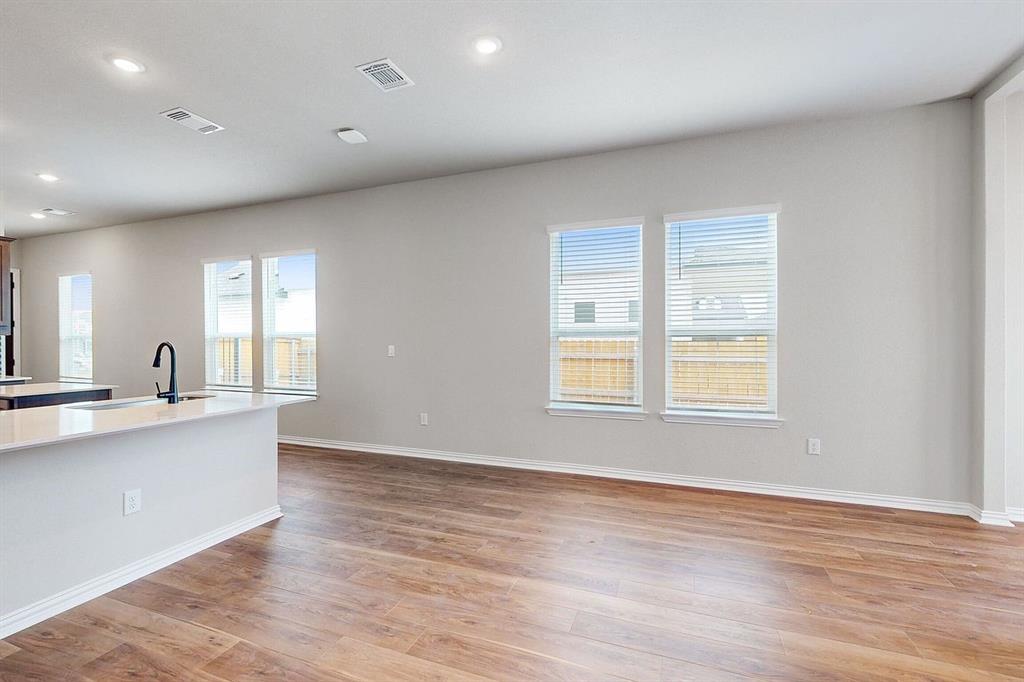 4907 Escape Rivera Drive Austin, TX 78747 - Photo 28 of 28 An open floorplan with rich hardwood floors and recessed lighting creates an inviting living space.