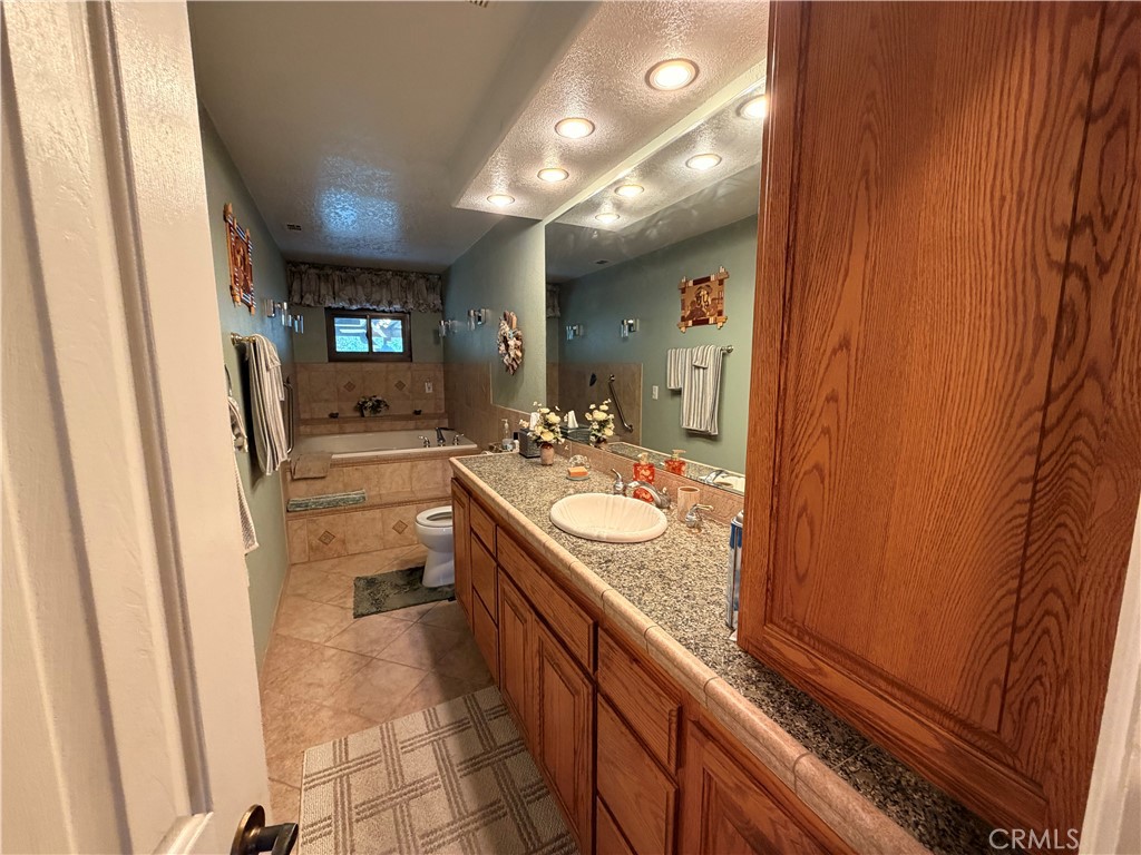 32360 Navajo Road Wildomar, CA 92595 - Photo 17 of 58 a bathroom with a sink and a mirror