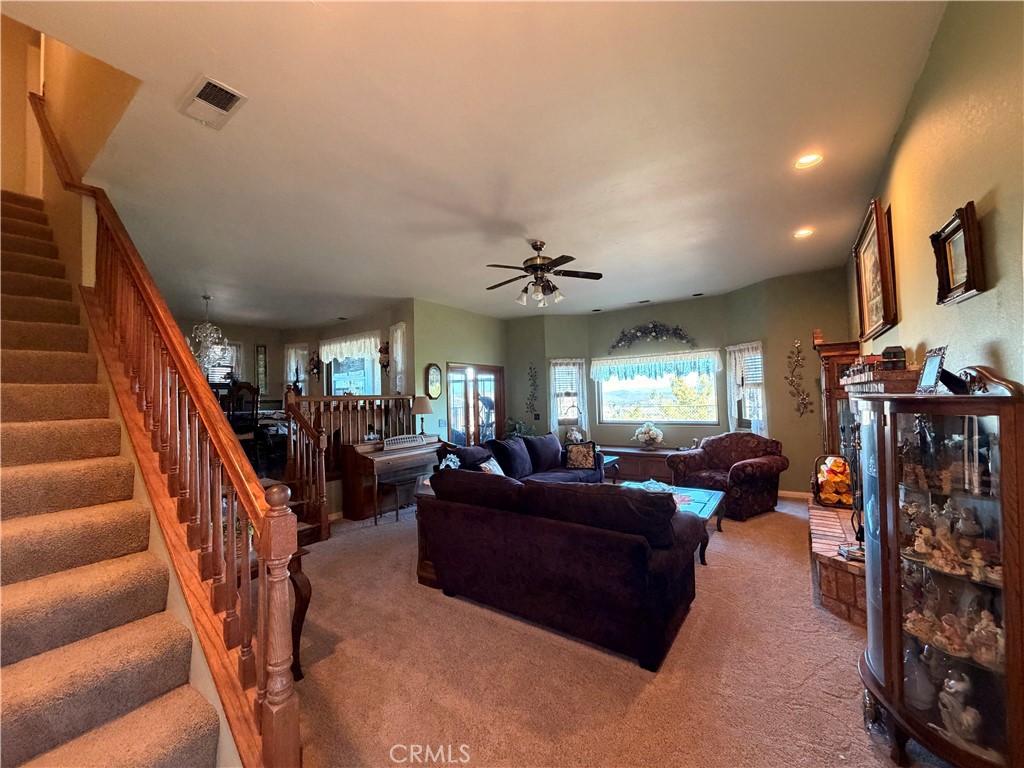 32360 Navajo Road Wildomar, CA 92595 - Photo 21 of 58 a living room with lots of furniture and stairs