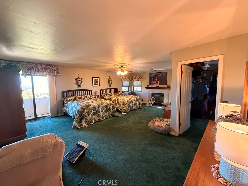 32360 Navajo Road Wildomar, CA 92595 - Photo 22 of 58 a bed room with furniture and a fireplace