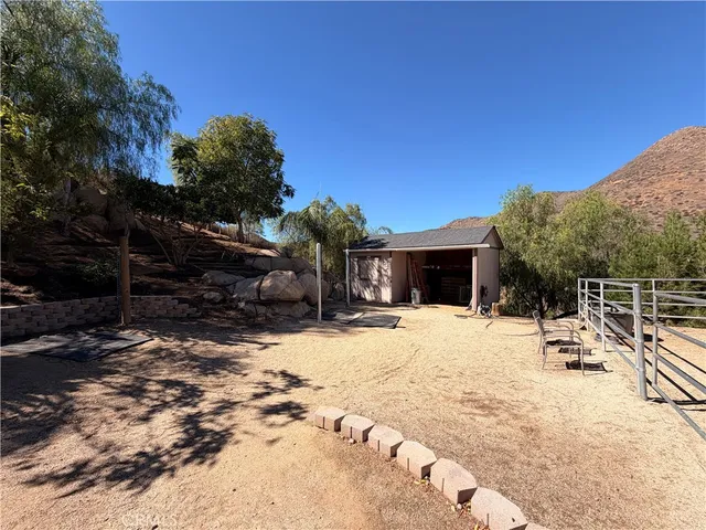 a view of a roof deck with a house in the background