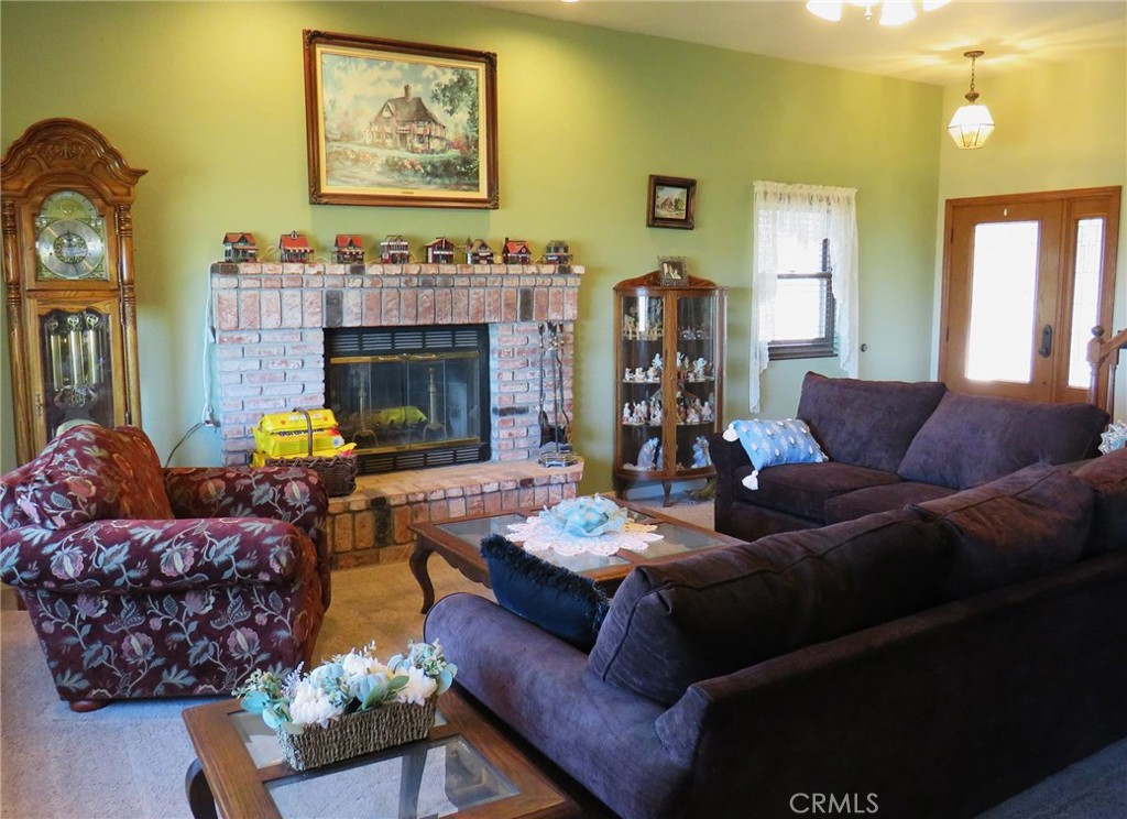 32360 Navajo Road Wildomar, CA 92595 - Photo 5 of 58 a living room with furniture flowerpot and a fireplace