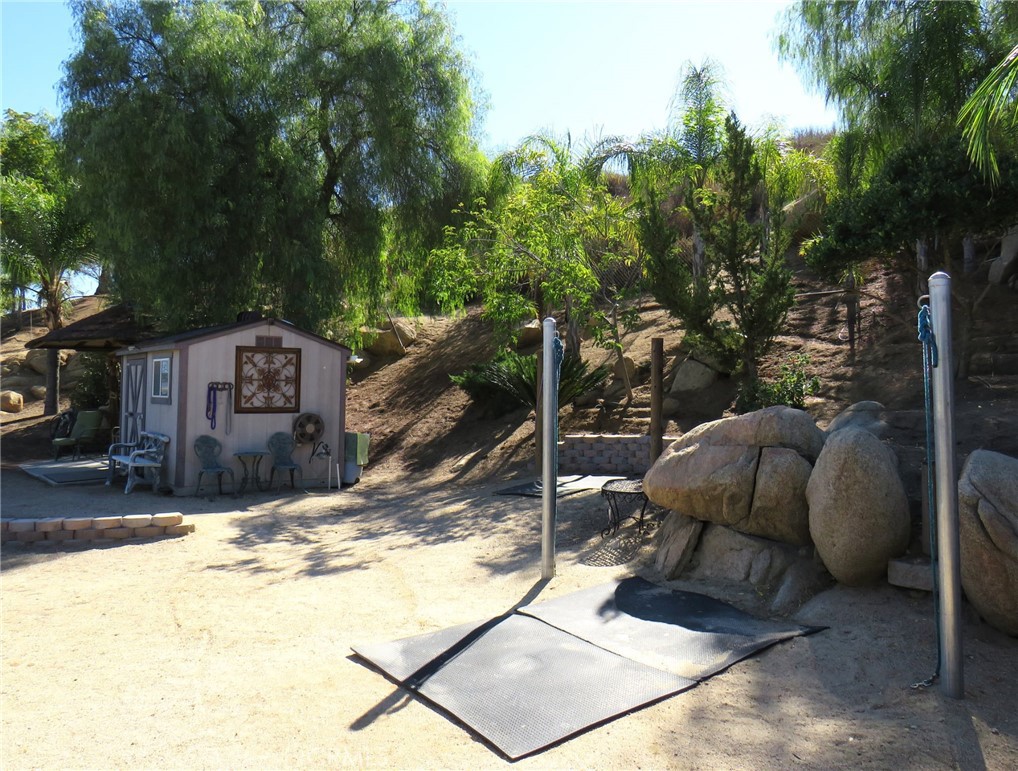 32360 Navajo Road Wildomar, CA 92595 - Photo 57 of 58 a view of a backyard with a large tree and wooden fence