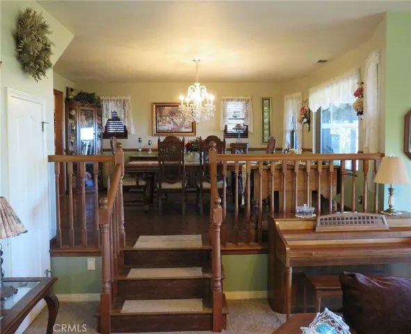 a view of a dining room with furniture and chandelier