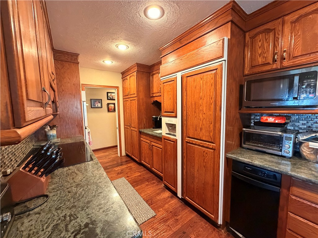 32360 Navajo Road Wildomar, CA 92595 - Photo 9 of 58 a kitchen with stainless steel appliances granite countertop a refrigerator and a stove top oven