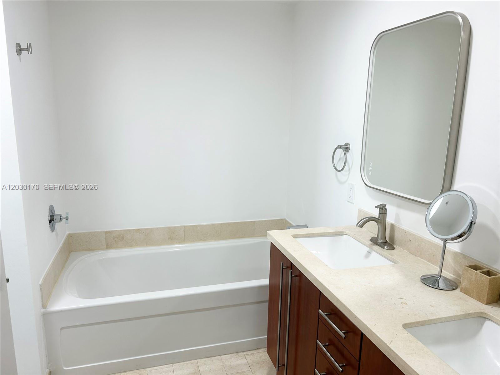 79 Southwest 12th Street, Unit 1710S Miami, FL 33130 - Photo 8 of 25 a bathroom with a sink and a bathtub