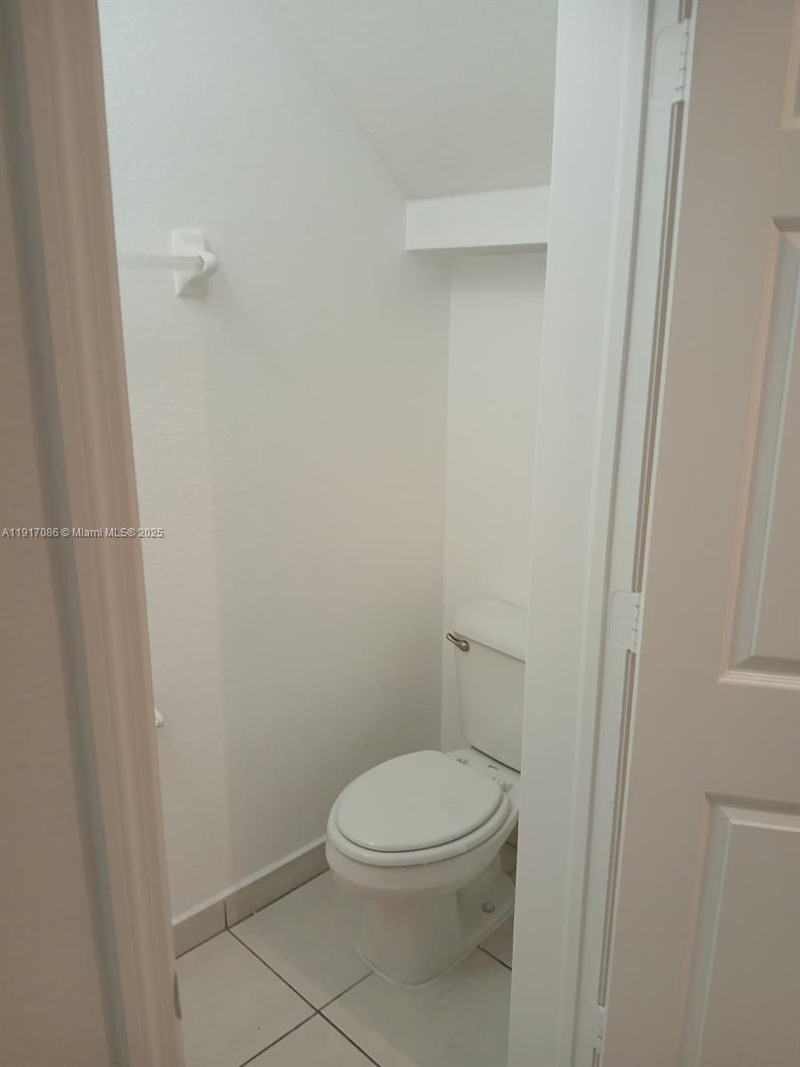 24386 Southwest 109th Court, Unit / Homestead, FL 33032 - Photo 16 of 33 a white toilet sitting next to a shower