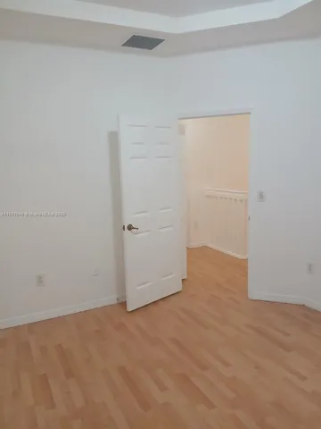 a view of an empty room with a fan