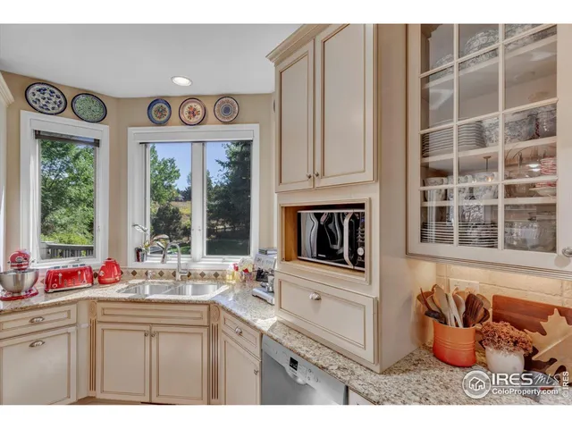 a kitchen with stainless steel appliances granite countertop a sink and cabinets