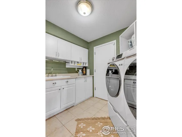 a utility room with sink dryer and washer