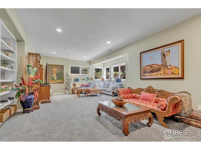 a living room with furniture a table and a large window