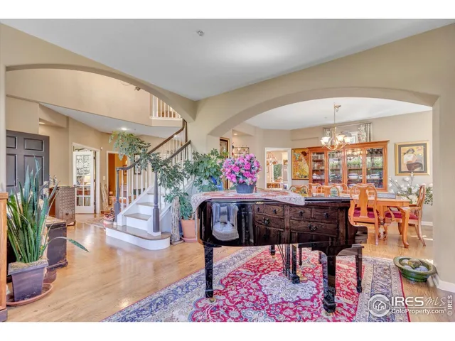 a living room with furniture and a dining table