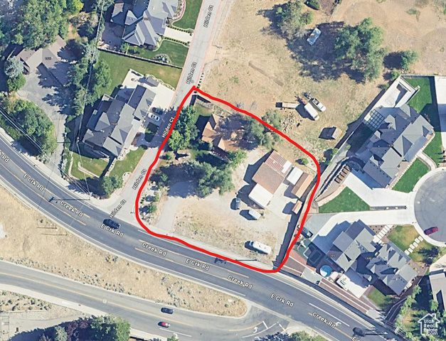 Aerial map of property and surrounding area featuring property boundaries highlighted