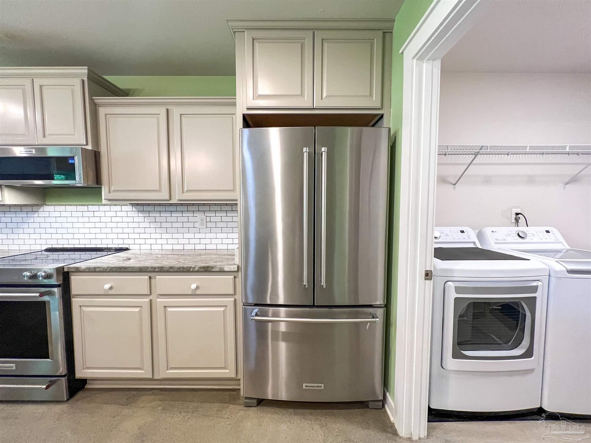 4906 Landmark Lane Pace, FL 32571 - Photo 11 of 34 a kitchen with cabinets and stainless steel appliances