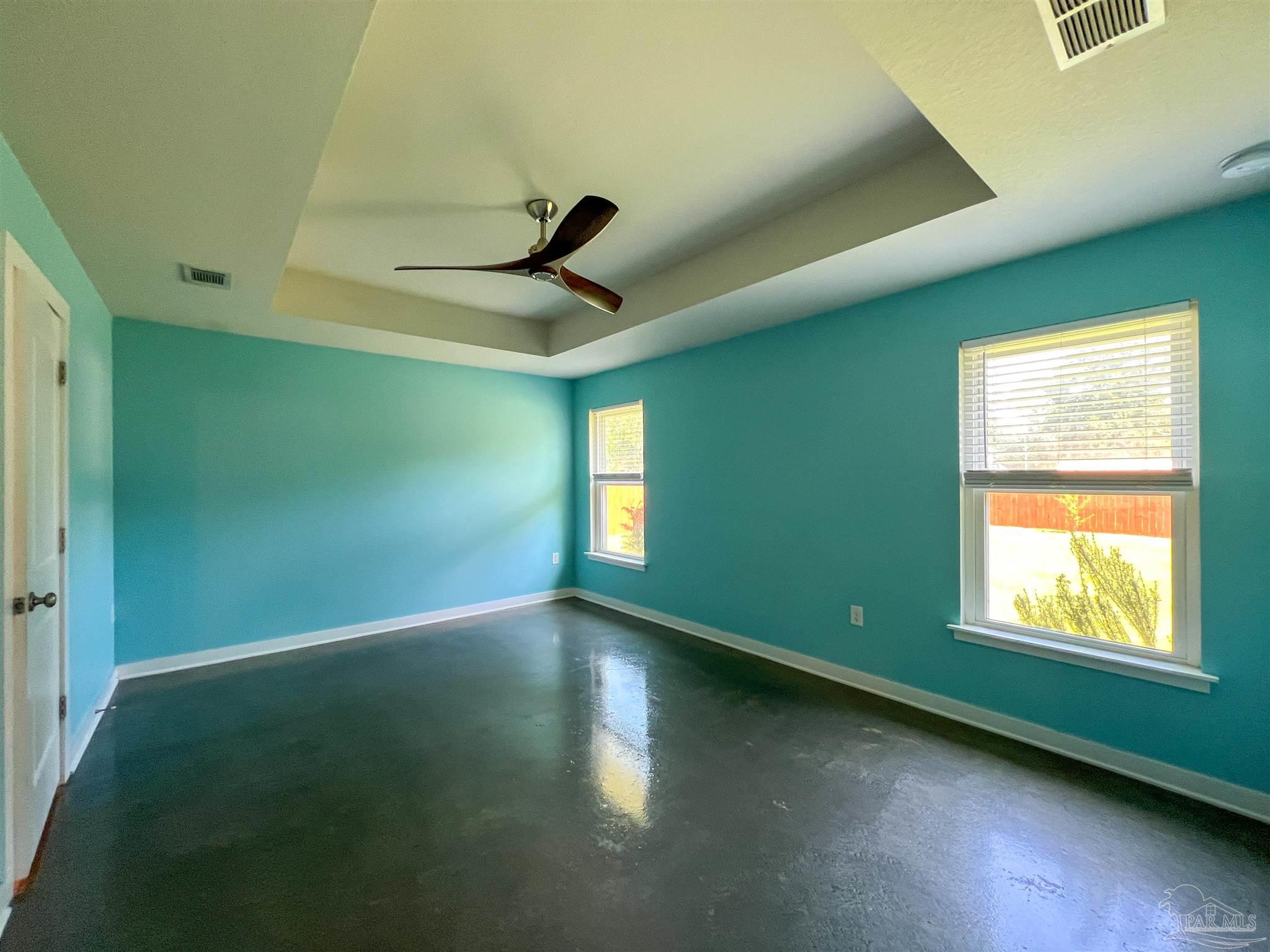 4906 Landmark Lane Pace, FL 32571 - Photo 13 of 34 a view of empty room with window and wooden floor
