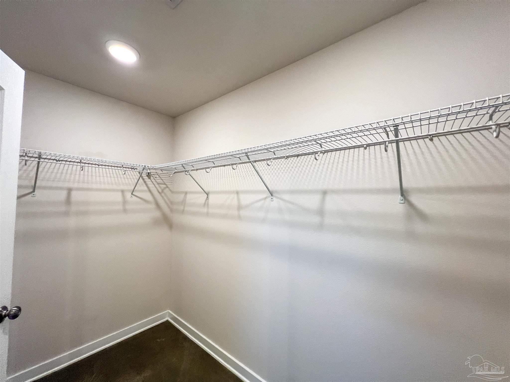 4906 Landmark Lane Pace, FL 32571 - Photo 17 of 34 a view of a room with racks on the wall