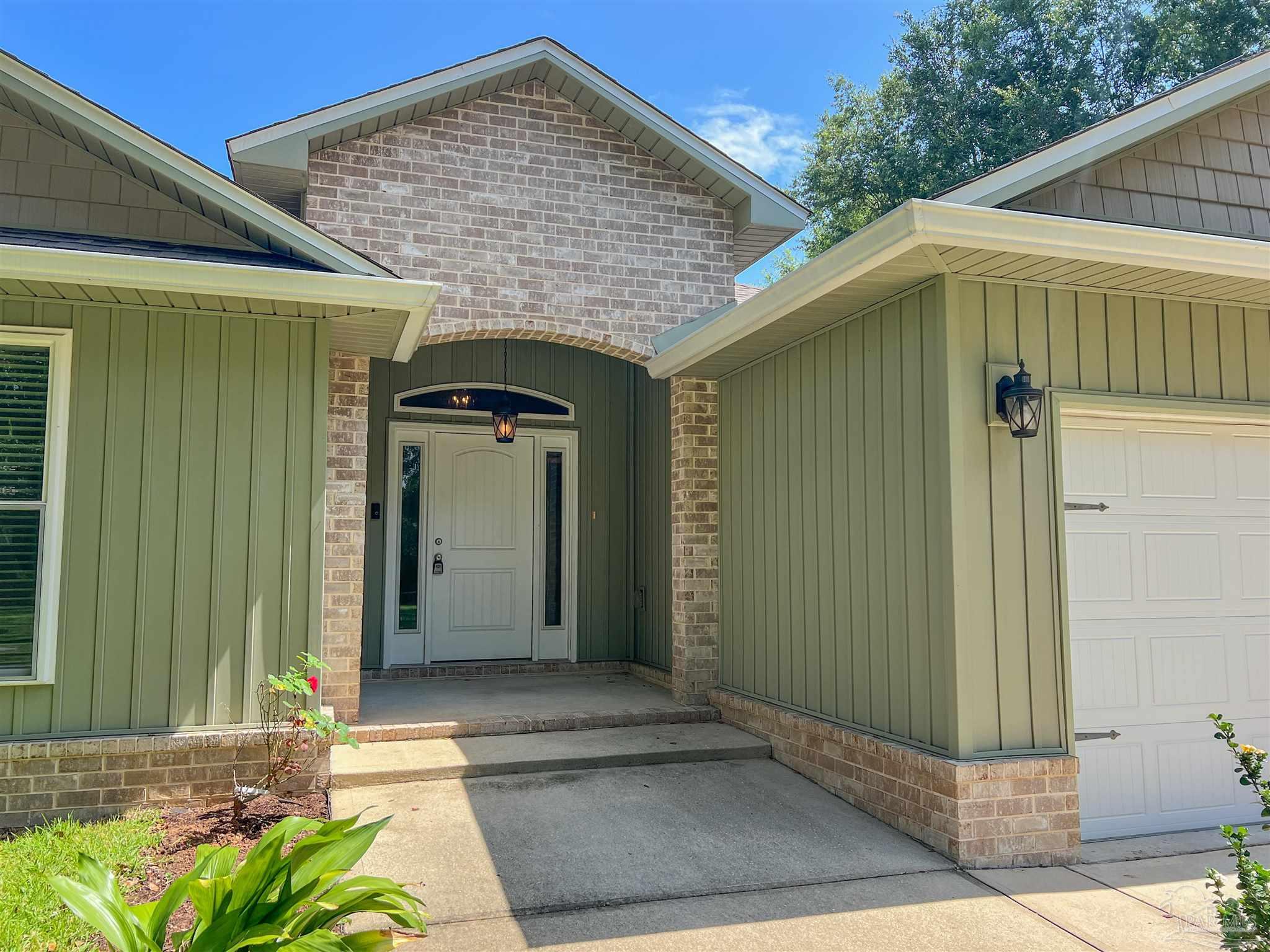 4906 Landmark Lane Pace, FL 32571 - Photo 2 of 34 a front view of a house