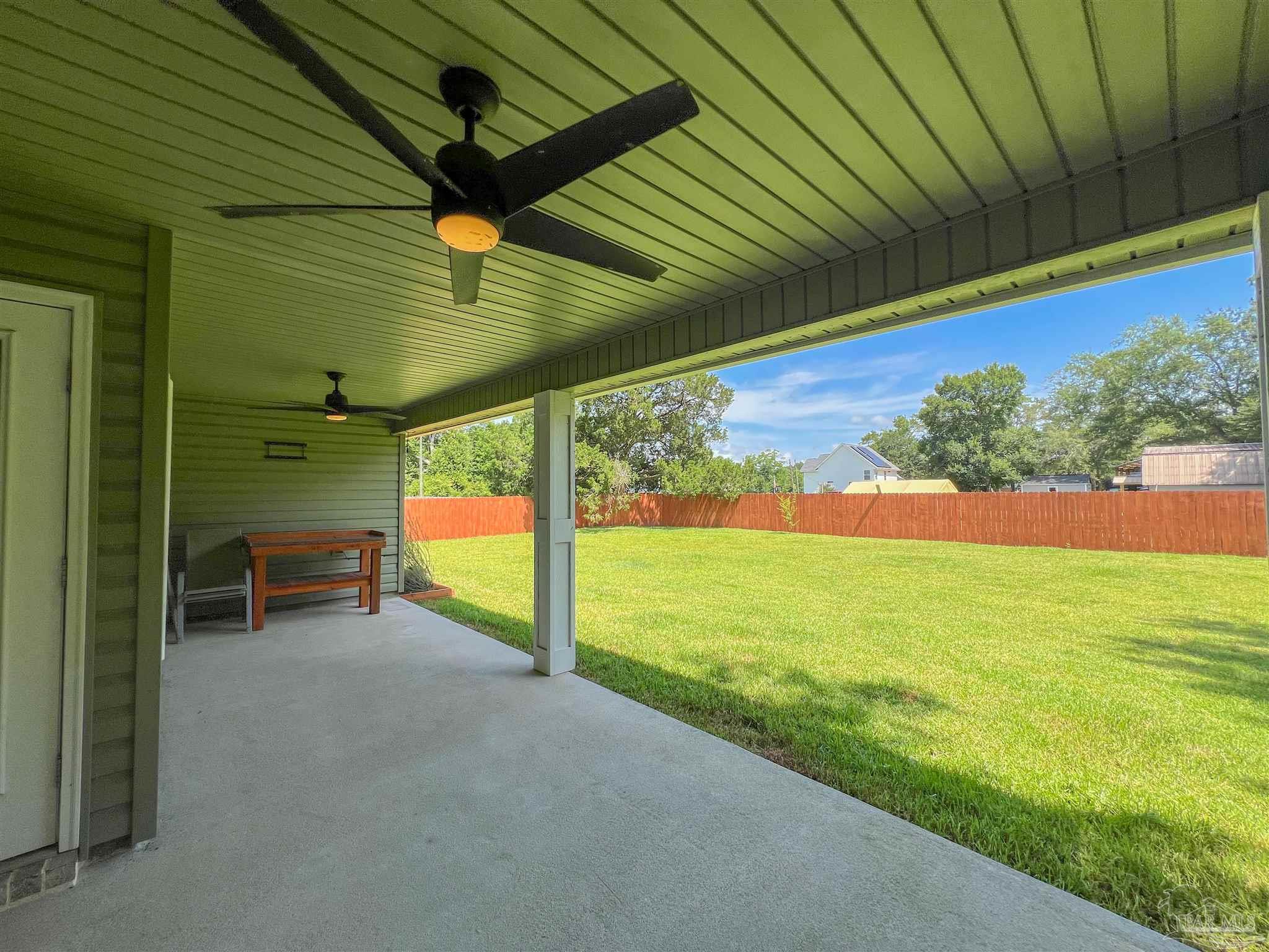 4906 Landmark Lane Pace, FL 32571 - Photo 30 of 34 a view of an chairs in the patio next to a yard