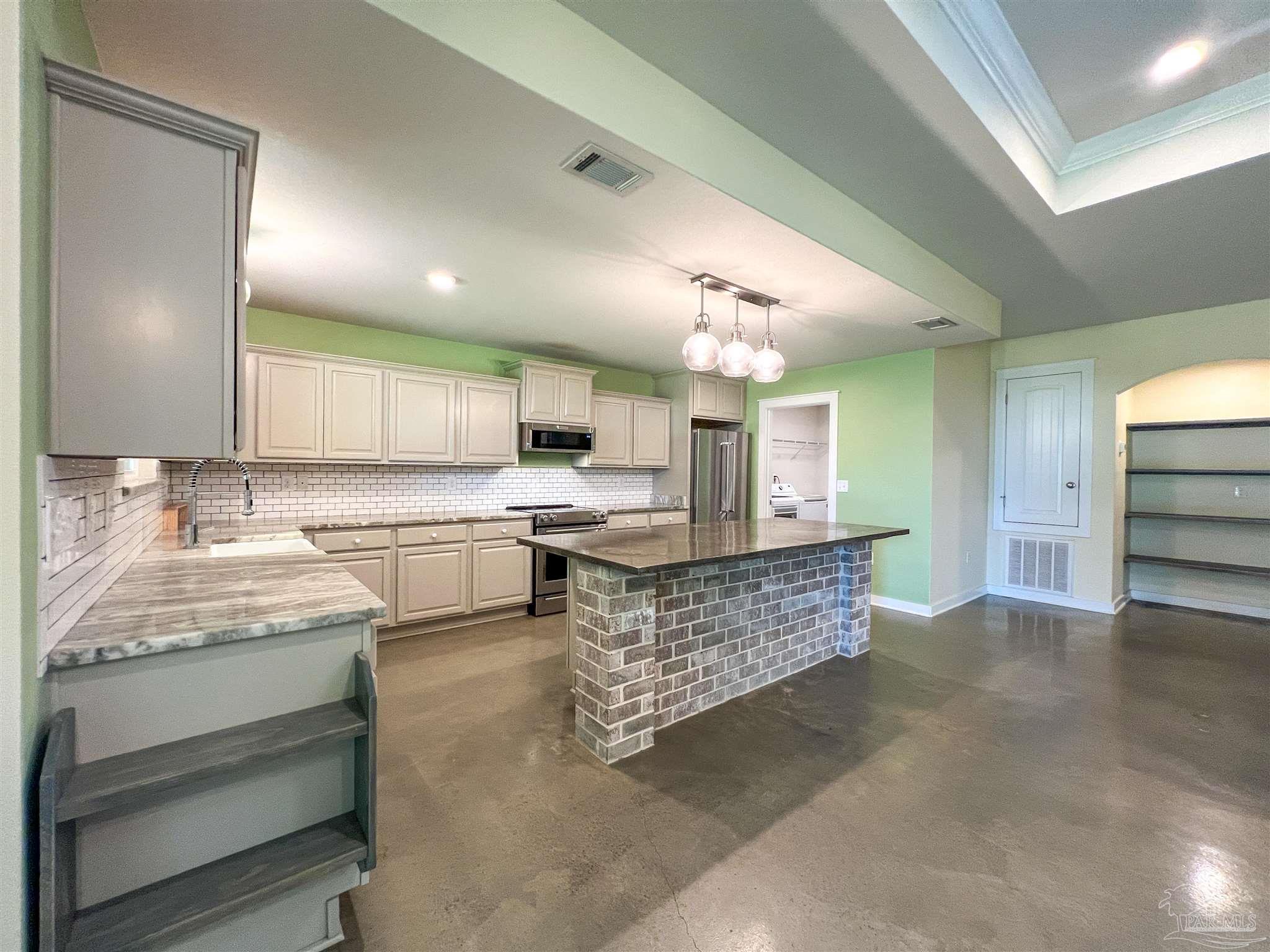 4906 Landmark Lane Pace, FL 32571 - Photo 4 of 34 a large living room with stainless steel appliances granite countertop furniture and a view of living room