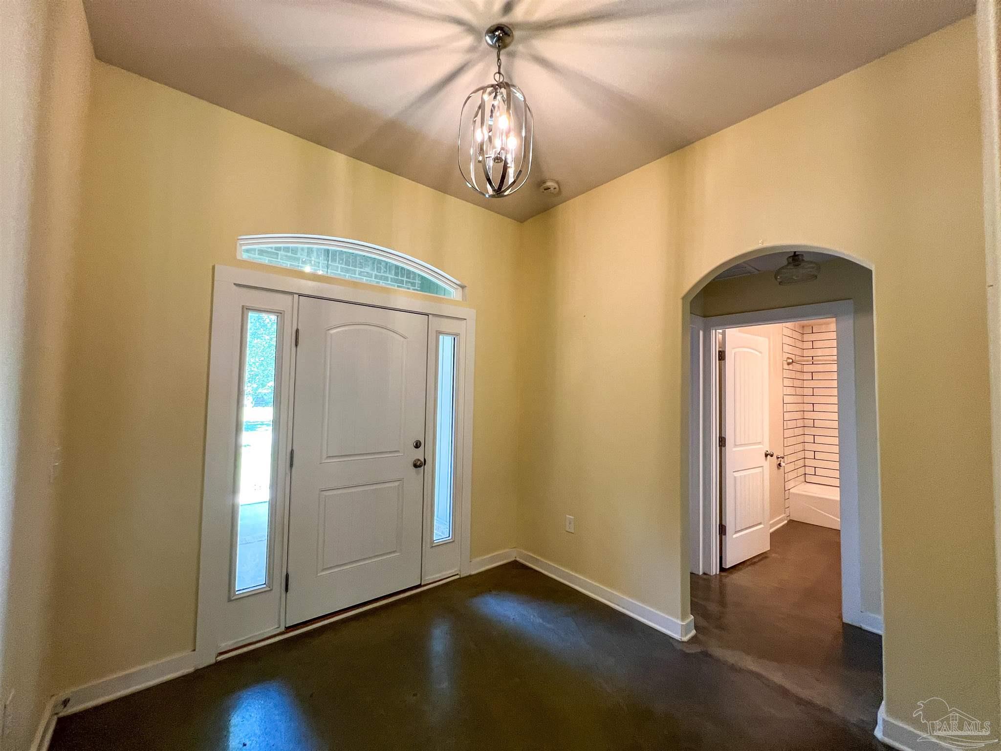 4906 Landmark Lane Pace, FL 32571 - Photo 9 of 34 an empty room with wooden floor fan and windows