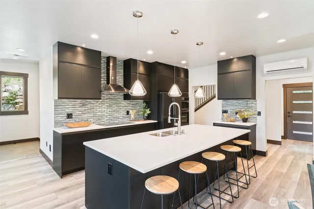 a kitchen with a sink a stove and chairs