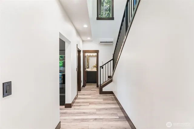 a view of a hallway with wooden floor and staircase