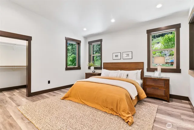 a bedroom with a large bed and a window