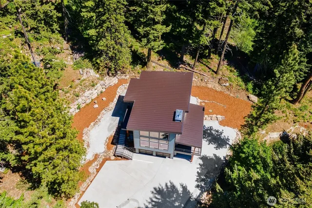 an aerial view of a house with a yard