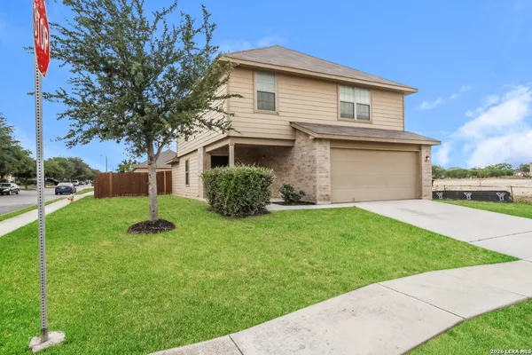 a view of a house with a backyard