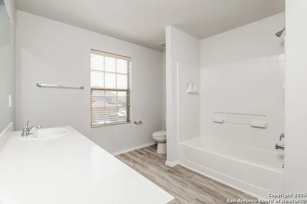 a bathroom with a bathtub and a sink