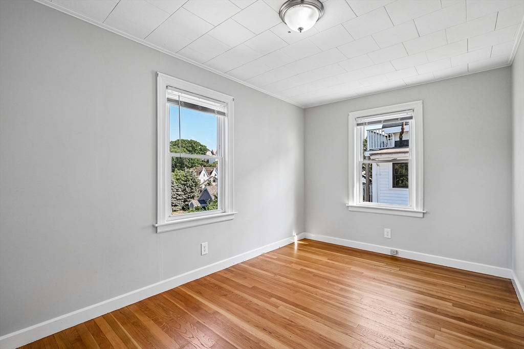 42 East Main Street Gloucester, MA 01930 - Photo 10 of 25 a view of an empty room with wooden floor and a window