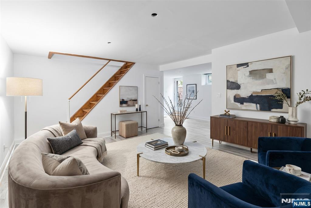 11 Adams Street Clifton, NJ 07011 - Photo 17 of 24 a living room with furniture and a wooden floor