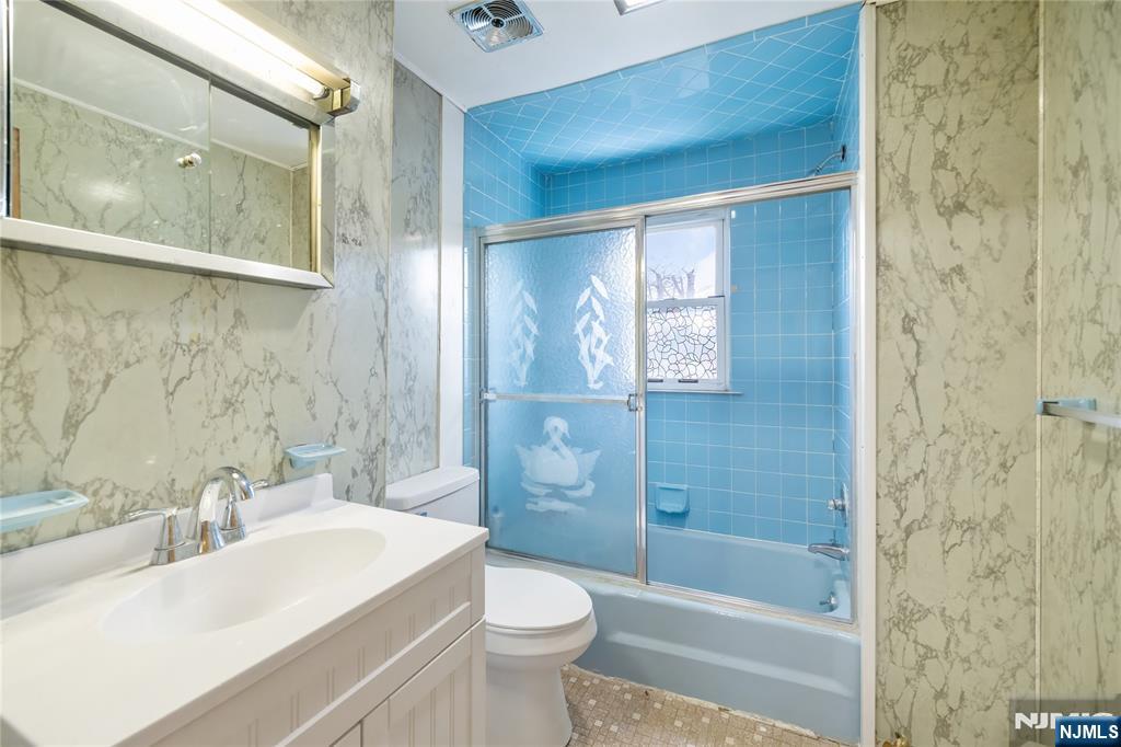 11 Adams Street Clifton, NJ 07011 - Photo 19 of 24 a bathroom with a sink a toilet and shower