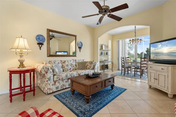 a living room with furniture a rug and a window