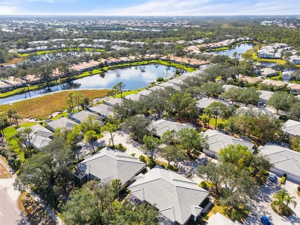 an aerial view of residential building and lake
